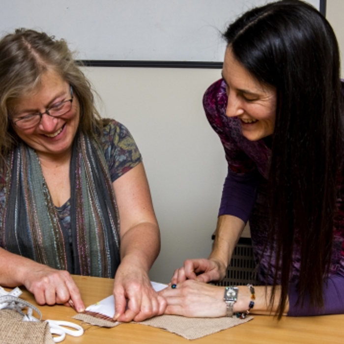 Two ladies sewing 