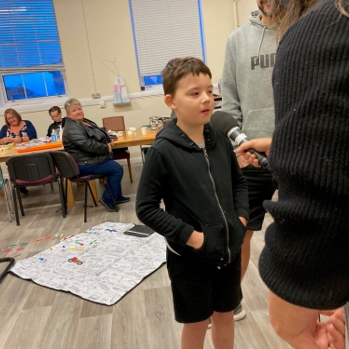 small boy speaking to interviewer 