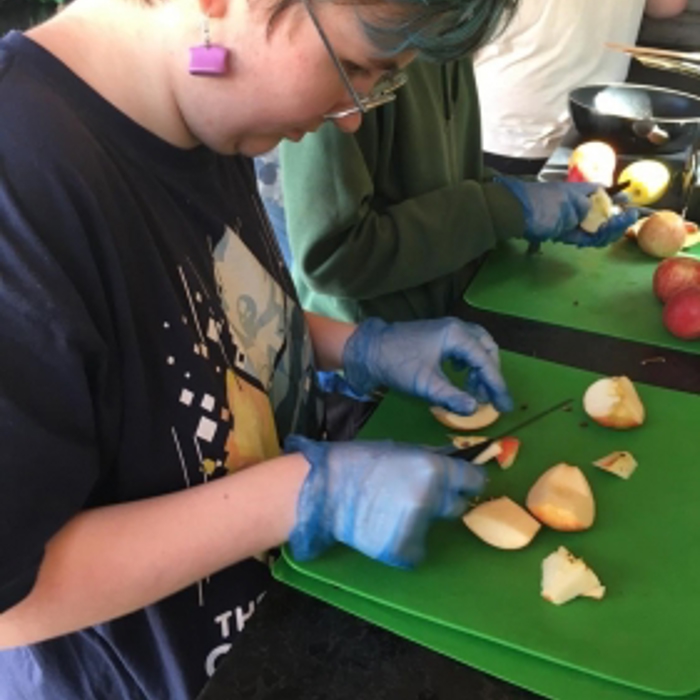 a girl cutting food