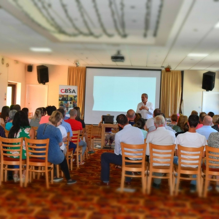 people sitting down watching a presentation 