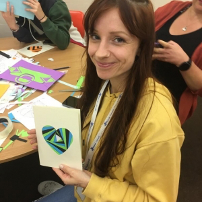 girl holding a card