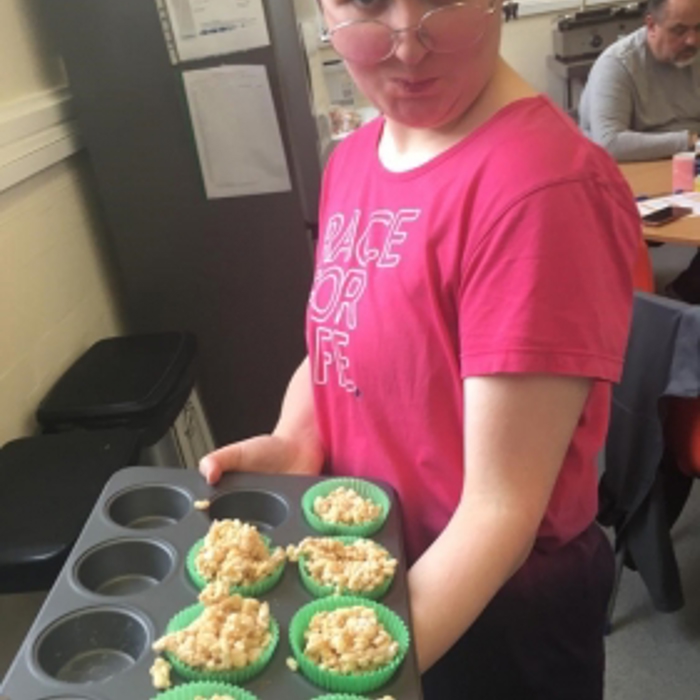 a girl showing off cupcakes